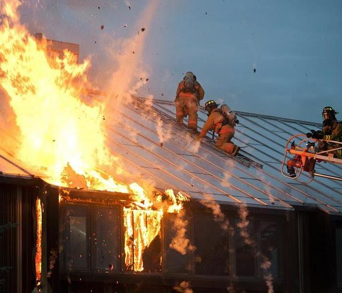 Firefighters on a commercial roof.