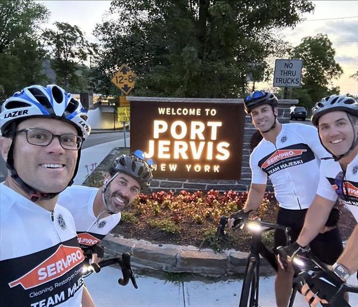 4 males wearing bike helmets