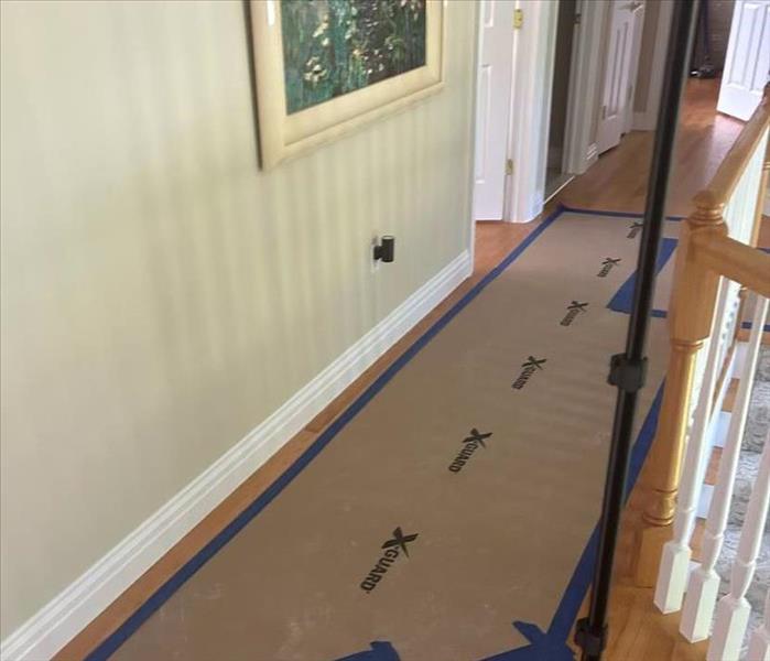 hallway floor with blue tape