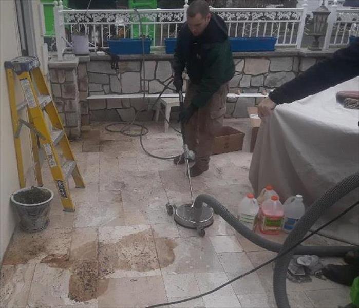 worker cleaning floor covered in soot