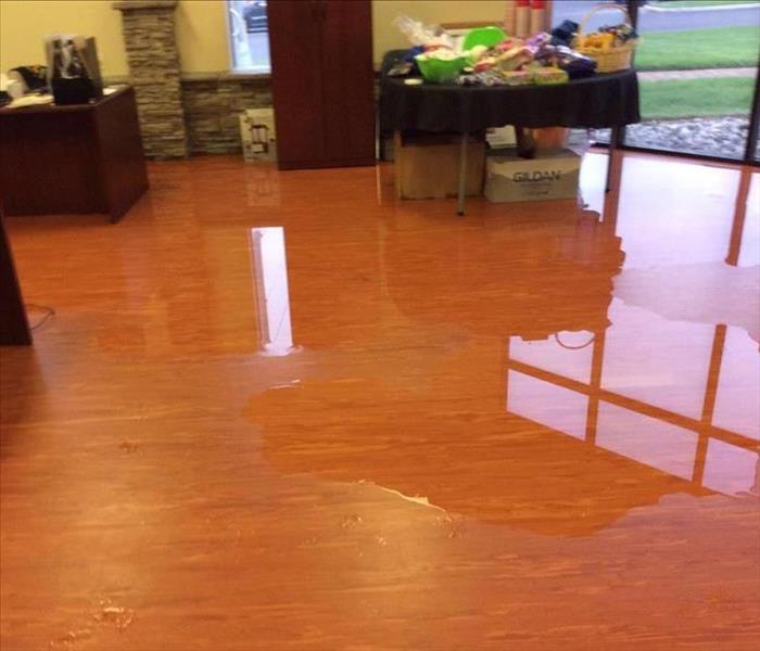 Water on the floor in an office.