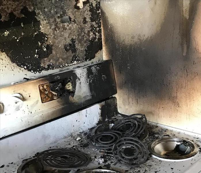 stove and wall charred by fire